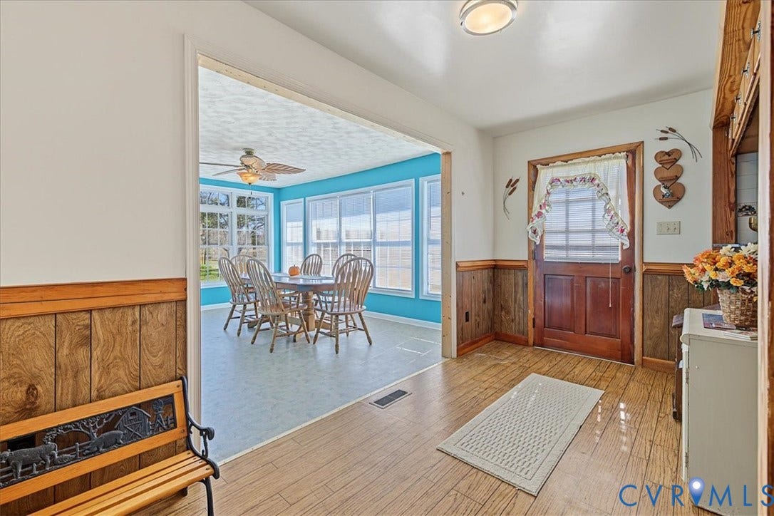 14421 Alden Road, Disputanta, VA 23842 Entryway featuring wood-finish flooring, wood wainscoting, and a solid wood front door with a glass inlay