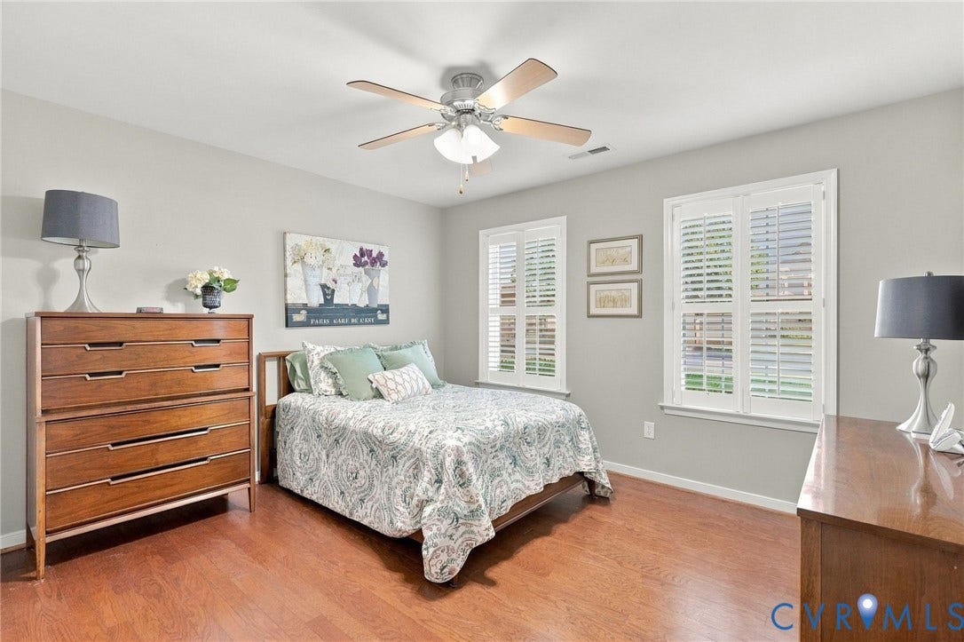8146 Janice Avenue, Mechanicsville, VA 23111 Room featuring wood-finish flooring, plantation shutters, and a central ceiling fan with integrated light fixture