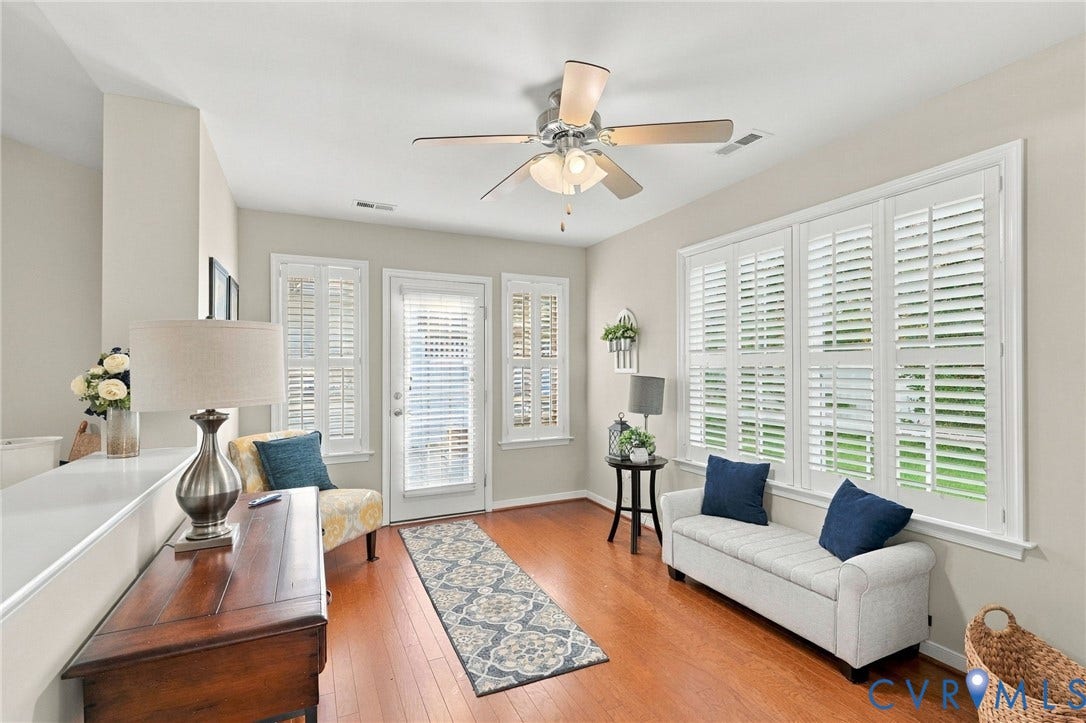 8146 Janice Avenue, Mechanicsville, VA 23111 Living area featuring wood-finish flooring, multi-paneled plantation shutters, an exterior glass-panel door, and a multi-blade ceiling fan with integrated lighting