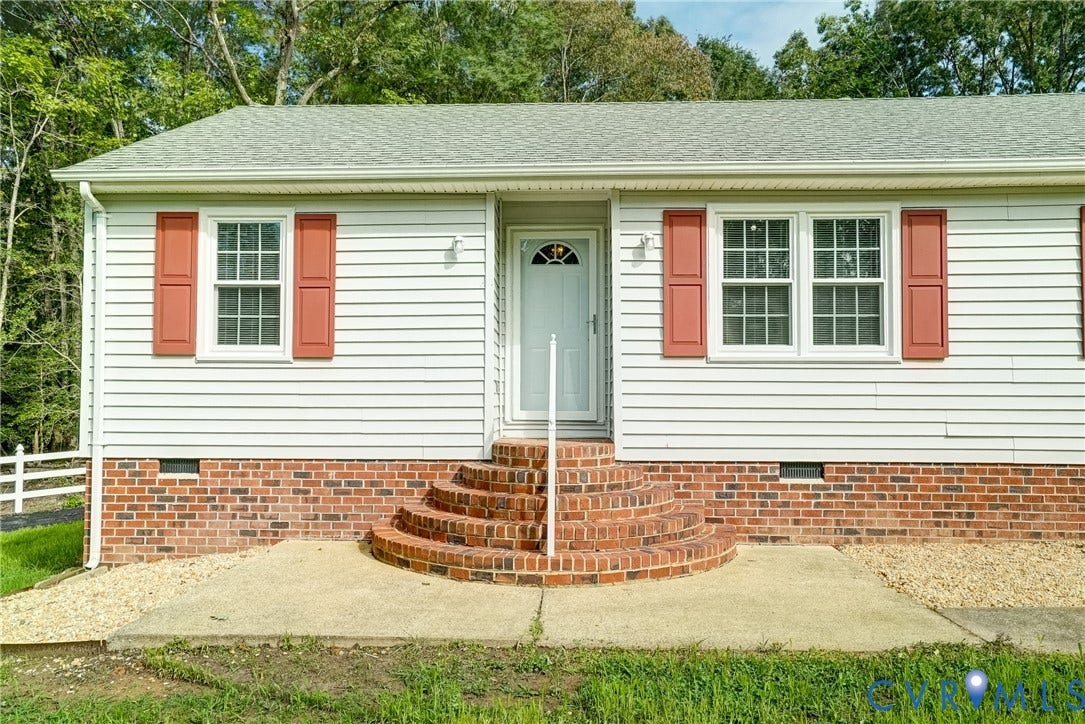 4130 Charles City Road, Charles City, VA 23231 Exterior featuring horizontal siding, a red brick foundation, semicircular brick front steps, and red louvered shutters