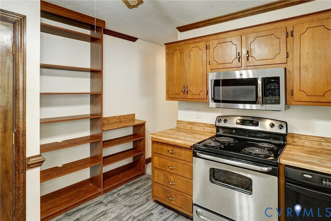 4130 Charles City Road, Charles City, VA 23231 Kitchen featuring wood cabinetry, integrated open shelving, wood-finish countertops, and stainless steel appliances
