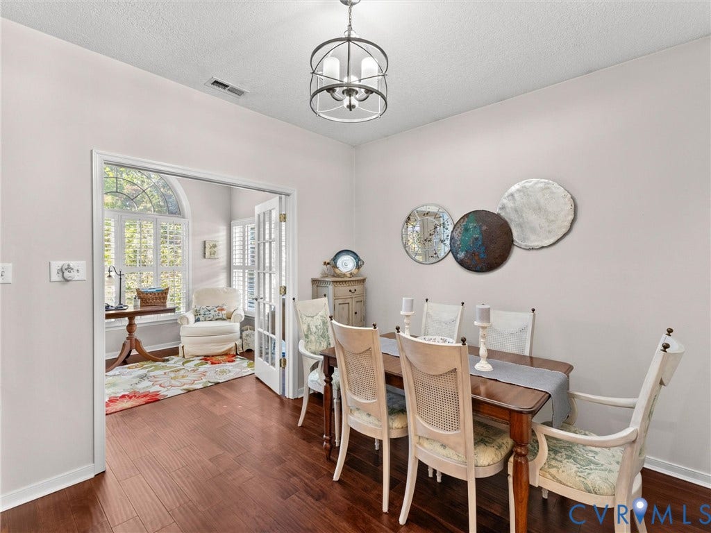4105 English Holly Circle, Glen Allen, VA 23294 Dark wood-finish flooring, architectural glass-paned French doors, and a modern tiered geometric chandelier