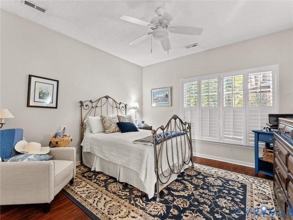 4105 English Holly Circle, Glen Allen, VA 23294 Interior space featuring wood-finish flooring, multi-pane window with white plantation shutters, and a ceiling fan with integrated lighting