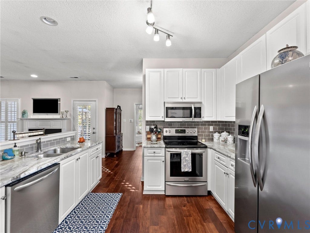 4105 English Holly Circle, Glen Allen, VA 23294 Kitchen featuring white cabinetry, stone-surface countertops, stainless steel appliances, a tile backsplash, and wood-finish flooring