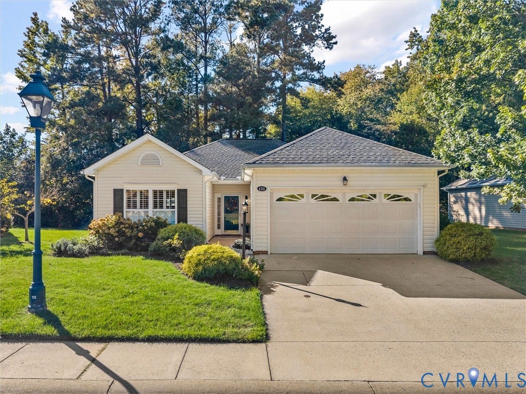 4105 English Holly Circle, Glen Allen, VA 23294 Single-story residence featuring light-colored siding, an attached two-car garage with arched decorative windows, a concrete driveway, and exterior lantern-style lighting