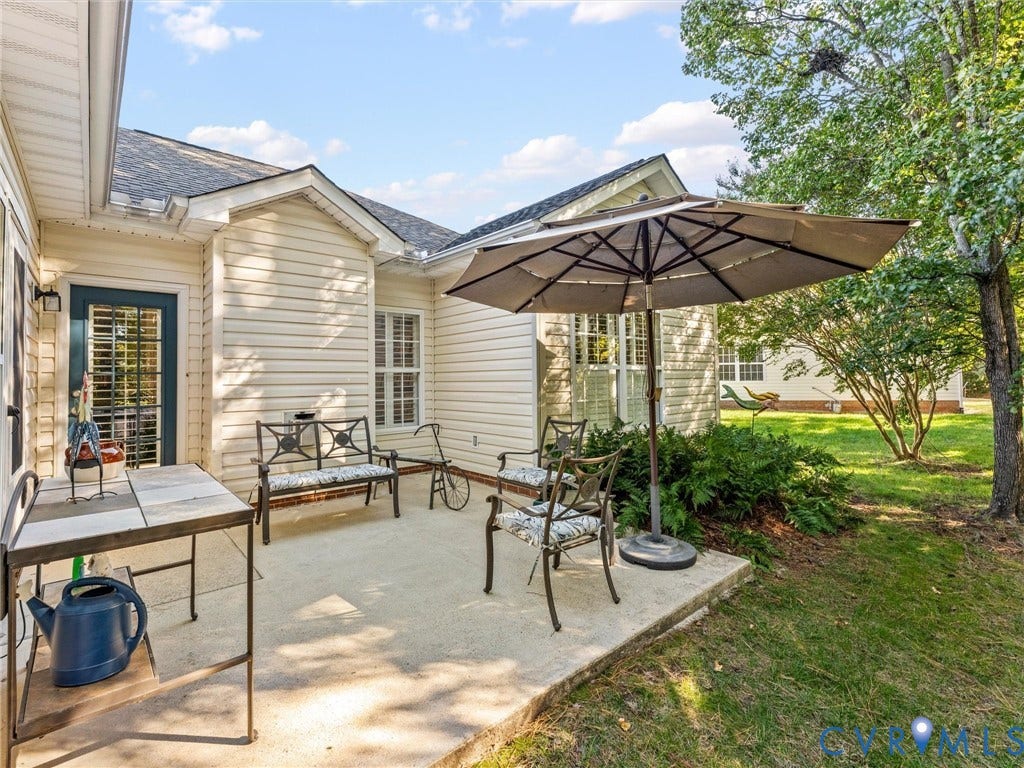 4105 English Holly Circle, Glen Allen, VA 23294 Concrete patio featuring vinyl siding, exterior lighting, and multi-pane windows