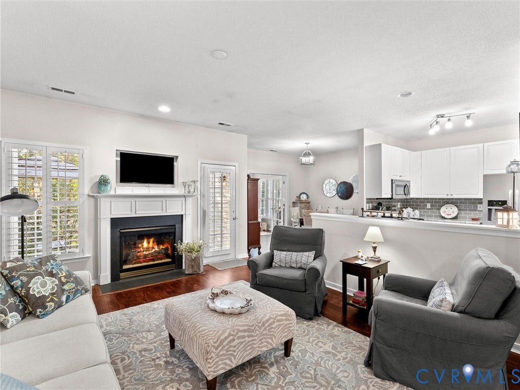 4105 English Holly Circle, Glen Allen, VA 23294 Fireplace with white mantle, wood-finish flooring, recessed lighting, and white cabinetry
