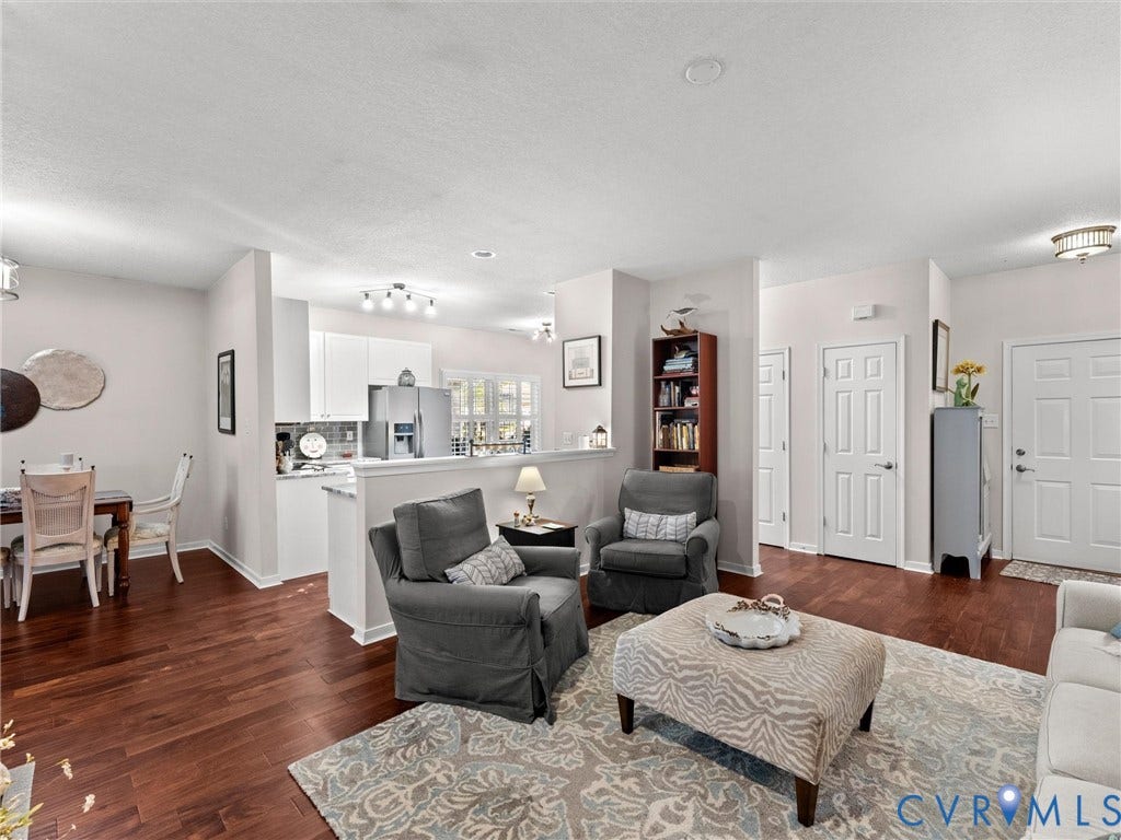 4105 English Holly Circle, Glen Allen, VA 23294 Open-concept interior featuring wood-finish flooring, recessed lighting, and a kitchen equipped with white cabinetry and stainless-steel appliances