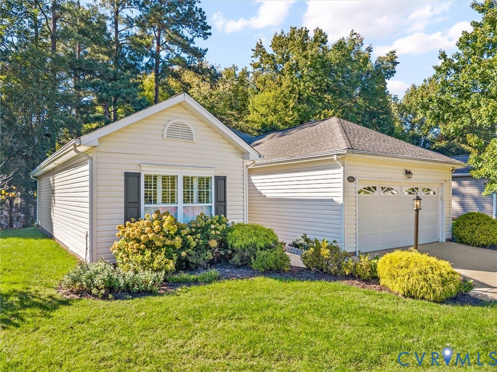 4105 English Holly Circle, Glen Allen, VA 23294 Vinyl-sided exterior featuring an attached two-car garage, manicured landscaping, arched window detailing, and a shingle roof