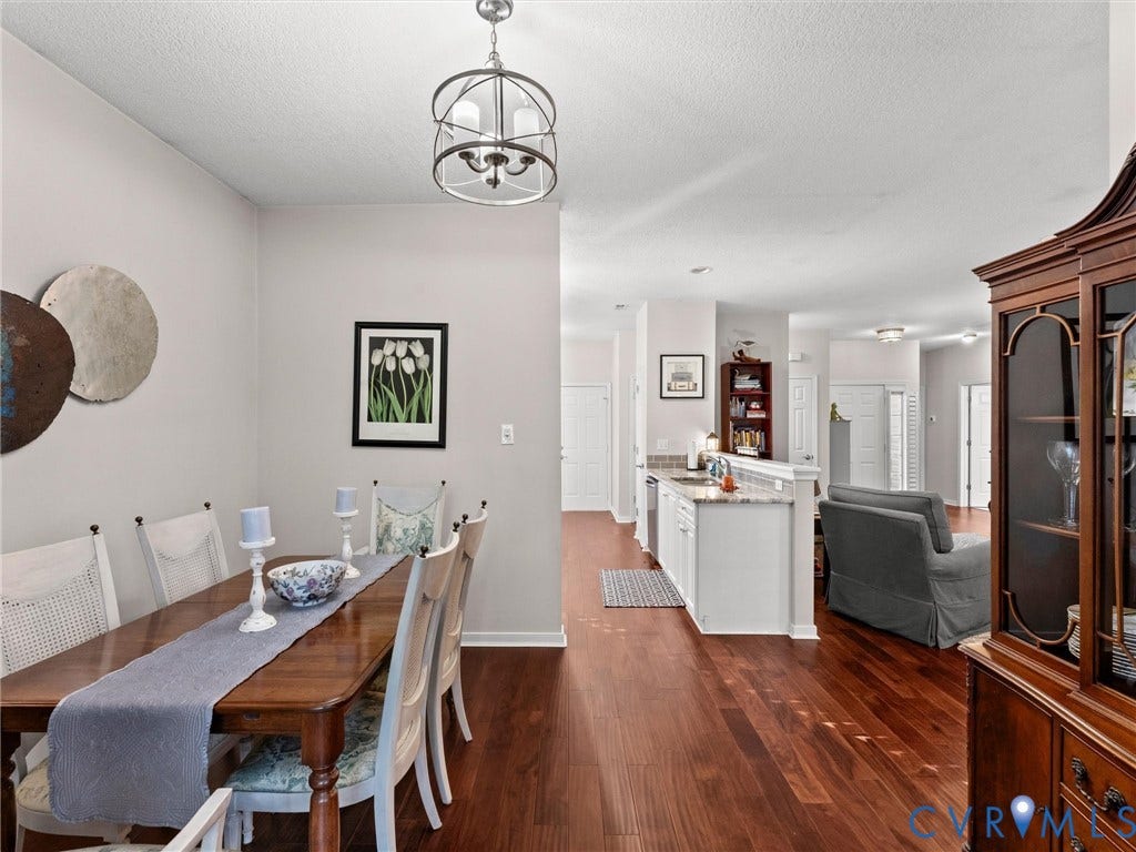 4105 English Holly Circle, Glen Allen, VA 23294 Wood-finish flooring, orb-style chandelier with three lights, and kitchen peninsula featuring a stone-look countertop