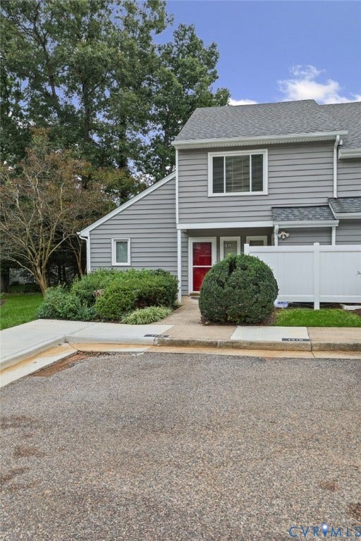 1415 Sycamore Mews Circle, Sycamore Mews, Midlothian, VA 23113 Two-story exterior featuring gray horizontal siding, asphalt shingle roofing, a concrete walkway, and a white privacy fence
