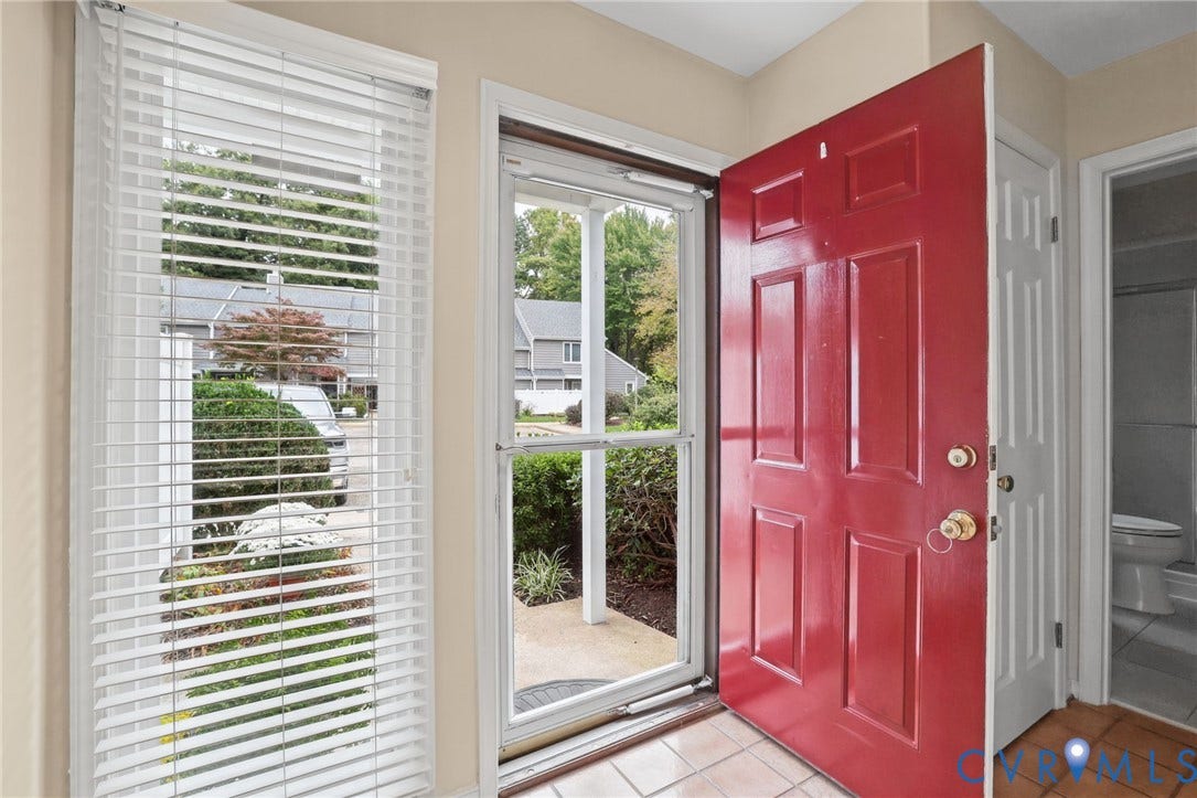 1415 Sycamore Mews Circle, Sycamore Mews, Midlothian, VA 23113 Entryway featuring a red six-panel front door, white storm door, window with horizontal blinds, and tile flooring