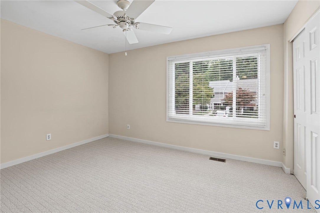 1415 Sycamore Mews Circle, Sycamore Mews, Midlothian, VA 23113 Neutral-toned interior featuring wall-to-wall carpeting, a multi-blade ceiling fan, and a large window with horizontal blinds