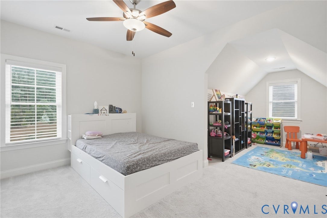 Glen Allen, VA 23059 Vaulted ceilings, neutral carpeting, multi-pane windows, and a central ceiling fan with integrated lighting