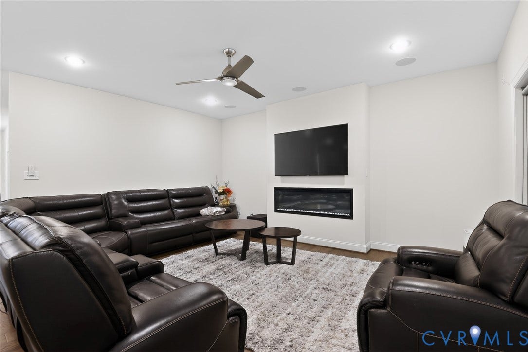 Glen Allen, VA 23059 Recessed ceiling lighting, linear wall-mounted electric fireplace, and multi-blade ceiling fan