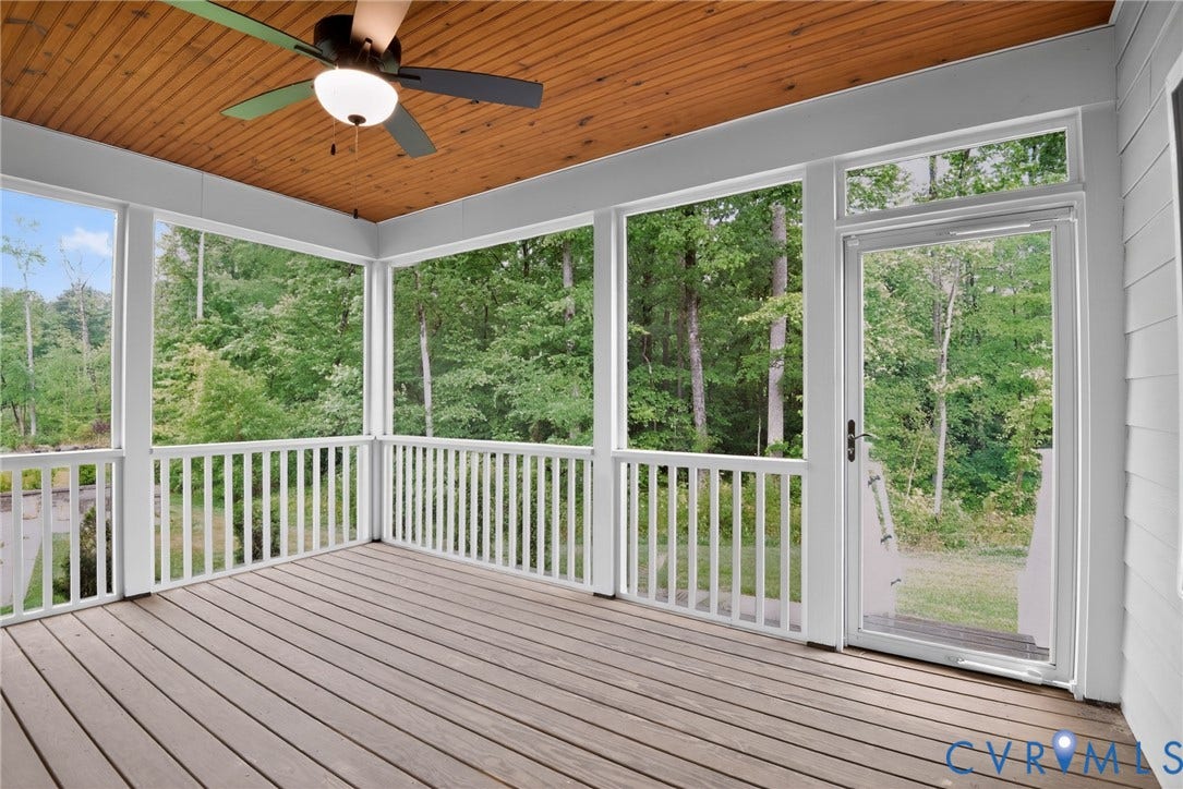 Glen Allen, VA 23059 Screened porch featuring a wood-plank ceiling, composite decking, white baluster railings, and a ceiling-mounted light fixture with a fan