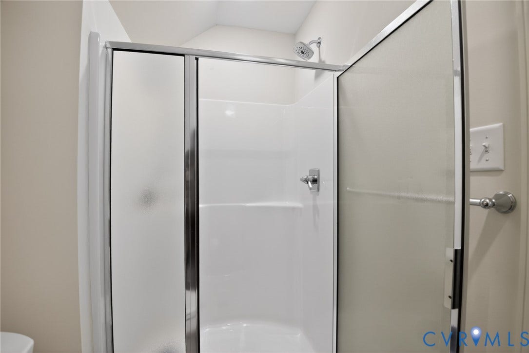 Glen Allen, VA 23059 Shower stall featuring a white acrylic surround, chrome fixtures, and a glass door with a metal frame