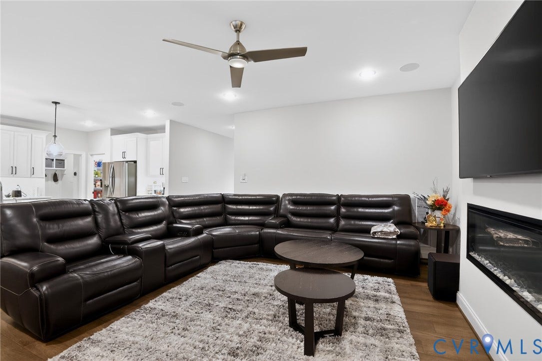 Glen Allen, VA 23059 Living area featuring recessed lighting, a ceiling fan, wood-finish flooring, and a wall-mounted horizontal fireplace