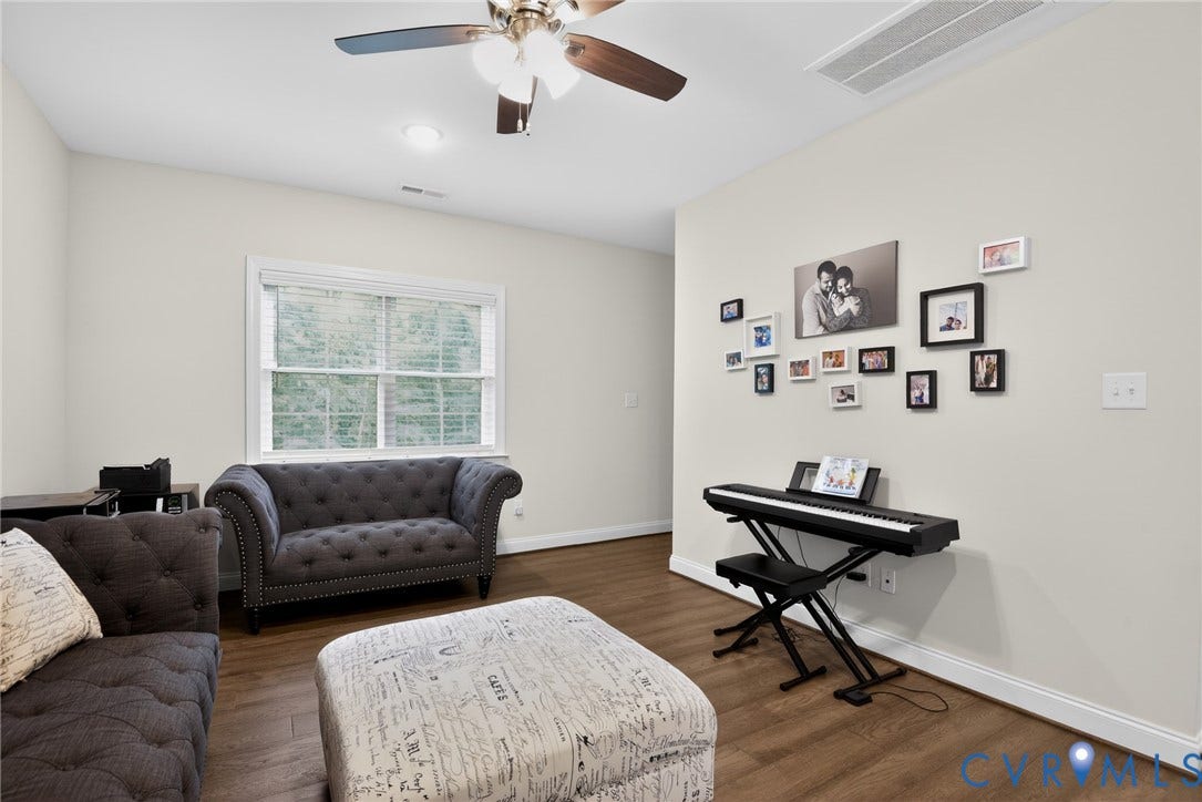 Glen Allen, VA 23059 Neutral-toned walls, wood-finish flooring, multi-pane window, and ceiling-mounted fan with integrated lighting