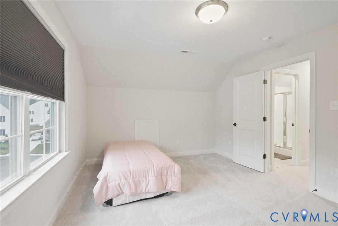 Glen Allen, VA 23059 Room featuring neutral carpet, sloped ceilings, a multi-pane window with a fitted shade, and a flush-mount ceiling light fixture