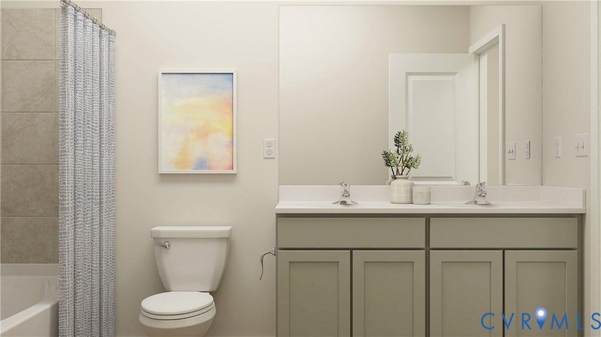 17313 Gossamer Drive, Chesterfield, VA 23120 Bathroom featuring a double vanity with grey shaker-style cabinetry, solid-surface countertop, dual drop-in sinks with chrome faucets, a full-width mirror, and a tiled shower surround