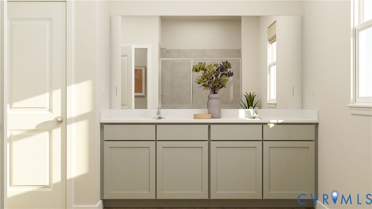 17313 Gossamer Drive, Chesterfield, VA 23120 Double vanity featuring shaker-style cabinetry, solid-surface countertop, dual drop-in sinks, and a full-width mirror