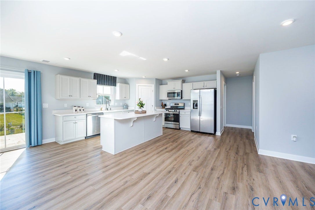 7577 Southamptonshire Way, Autum Pines, New Kent, VA 23124 Kitchen Area with large central island with countertop seating, white shaker-style cabinetry, stainless steel appliances and walk in pantry