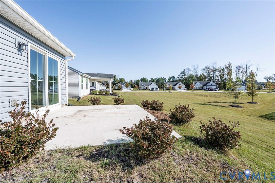 7577 Southamptonshire Way, Autum Pines, New Kent, VA 23124 Large Patio overlooking open-space lawn area with established landscaping.