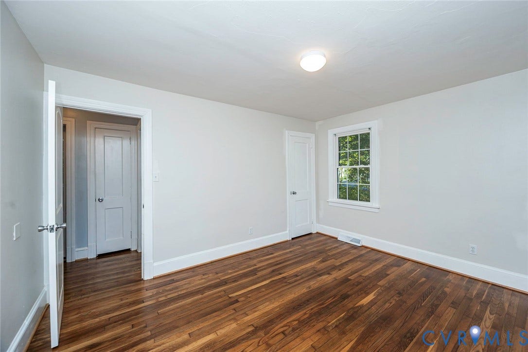 3017 Kingsdale Road, Chesterfield, VA 23237 Interior room featuring wood-finish flooring, two-panel interior doors, a multi-pane window, and a flush-mount ceiling light fixture