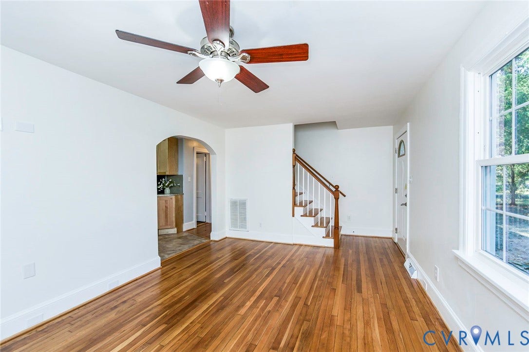 3017 Kingsdale Road, Chesterfield, VA 23237 Hardwood flooring, arched entryway, wooden staircase with white spindles, and ceiling fan with integrated light fixture