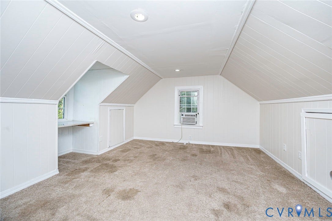 3017 Kingsdale Road, Chesterfield, VA 23237 Attic space featuring vaulted tongue-and-groove paneling, built-in storage cabinetry, a recessed desk alcove, neutral carpeting, and integrated lighting