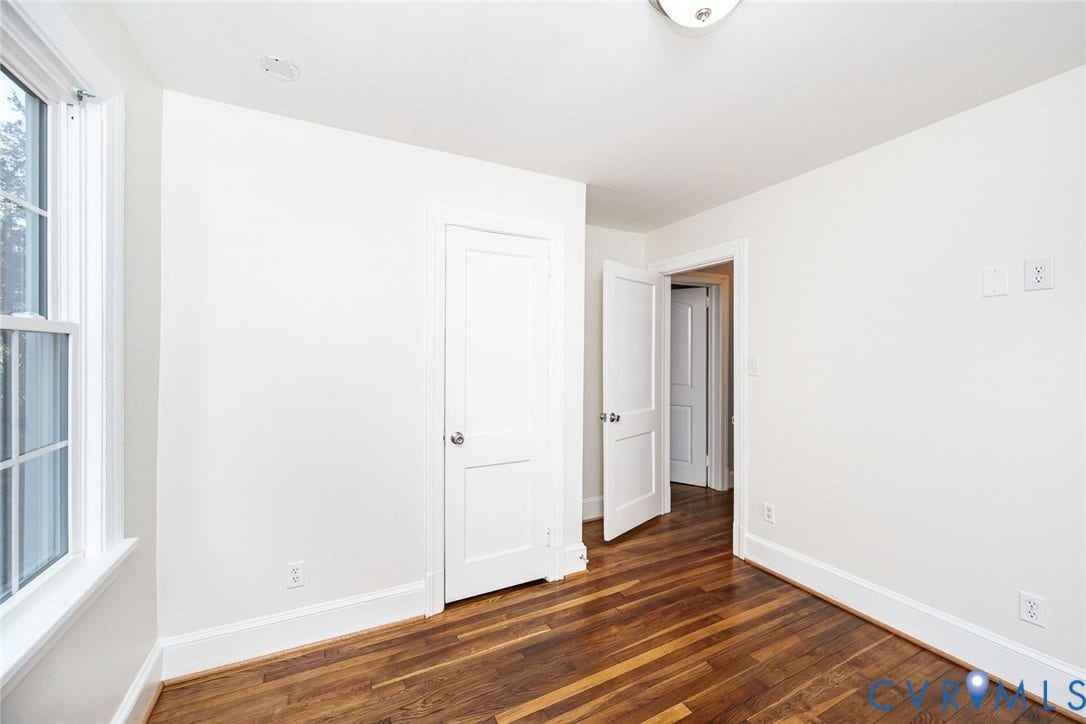 3017 Kingsdale Road, Chesterfield, VA 23237 Room featuring wood-finish flooring, white walls, two-panel interior doors, and a double-hung window with a muntin grid