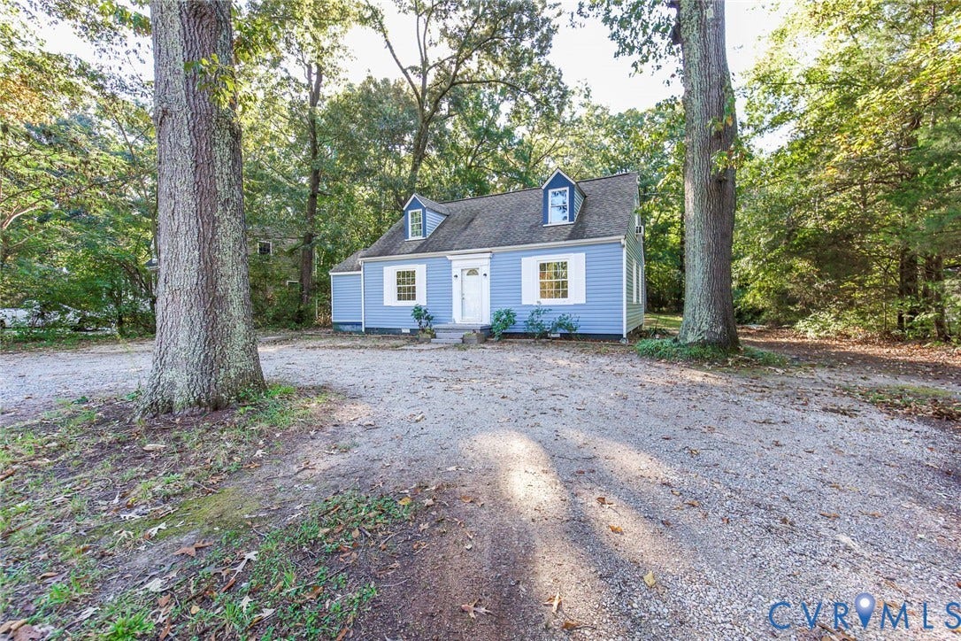 3017 Kingsdale Road, Chesterfield, VA 23237 Cape Cod style residence featuring blue horizontal siding, white window shutters, two roof dormers, and a gravel driveway