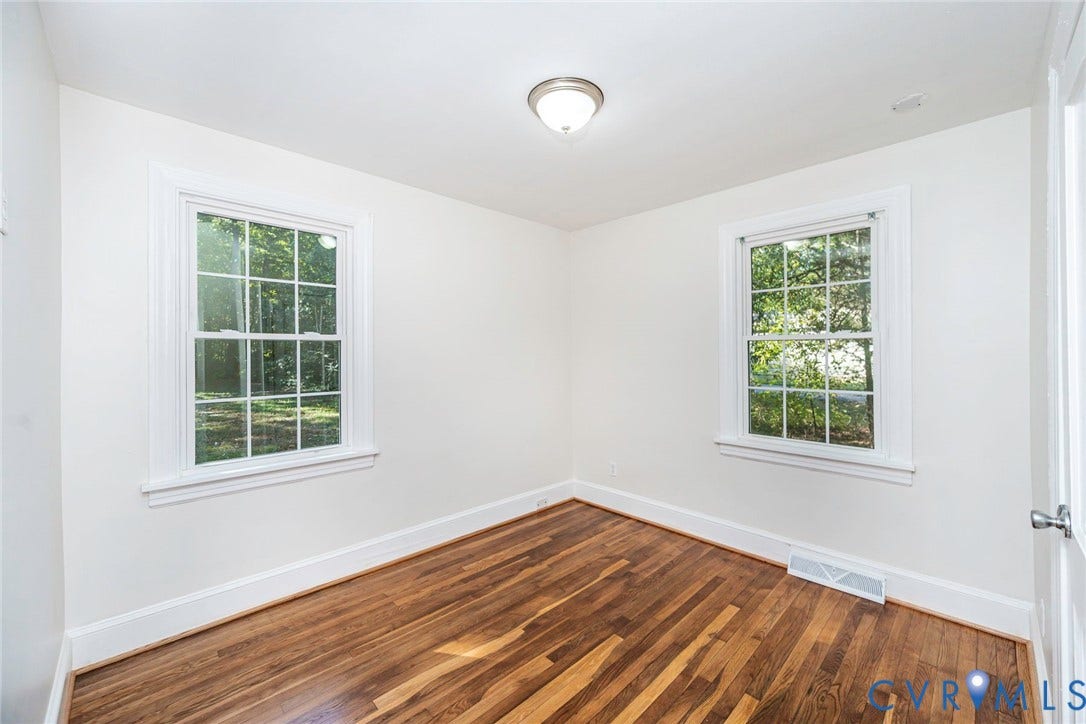 3017 Kingsdale Road, Chesterfield, VA 23237 Interior space featuring wood-finish flooring, two multi-pane windows with white trim, and a ceiling-mounted light fixture