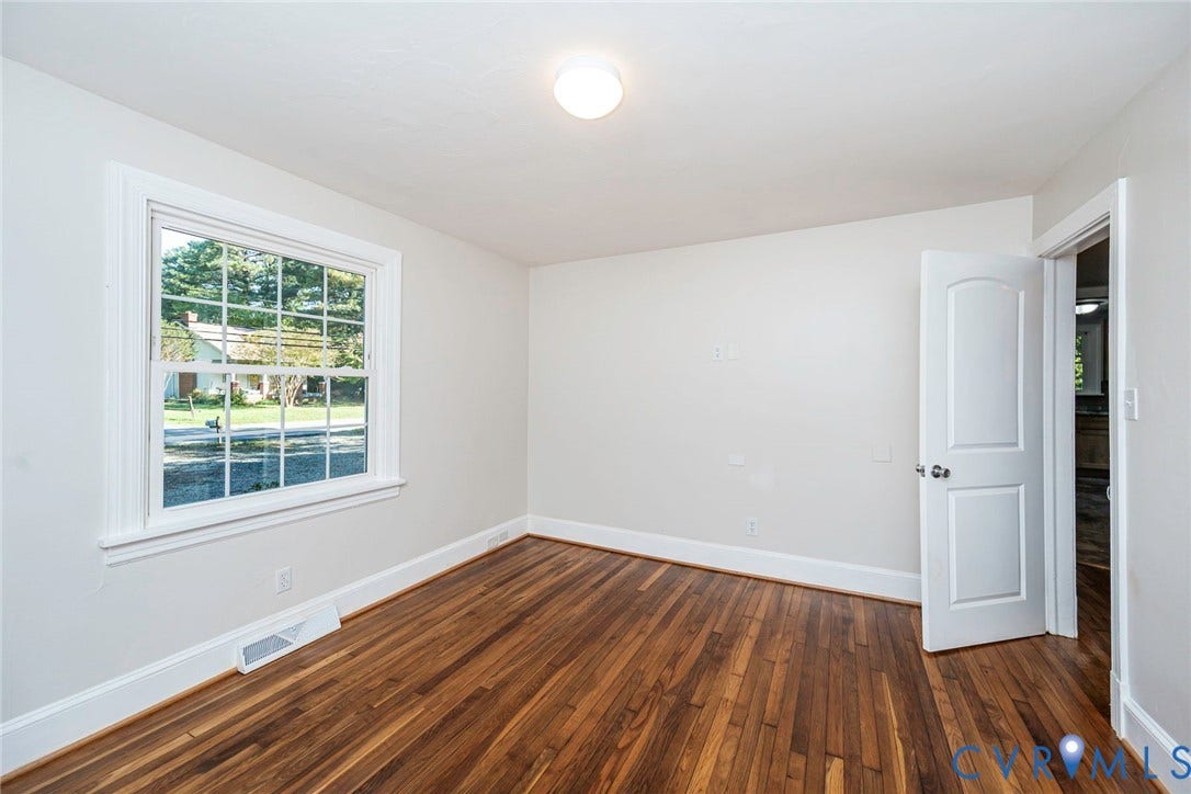 3017 Kingsdale Road, Chesterfield, VA 23237 Room featuring wood-finish flooring, a multi-pane window, flush-mount lighting, and a two-panel arched interior door