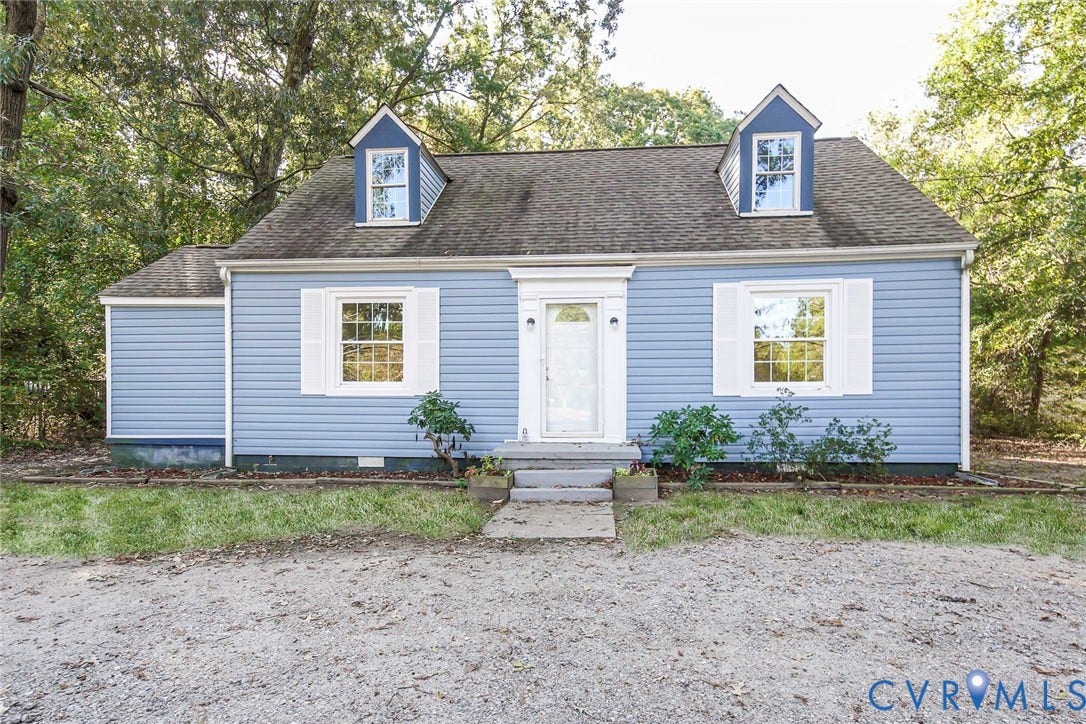 3017 Kingsdale Road, Chesterfield, VA 23237 Cape Cod style exterior featuring blue horizontal siding, white shutters, dual roof dormers, and a central entry door with pilasters