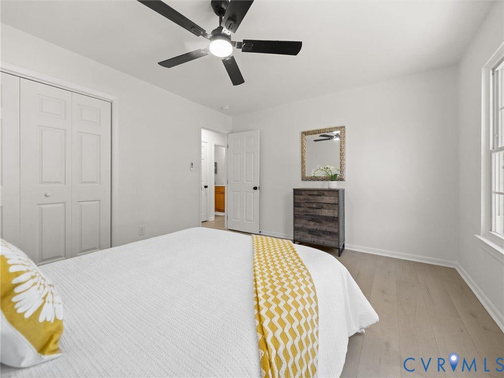 5105 Carryback Drive, Richmond, VA 23234 Room featuring neutral wall paint, wood-finish flooring, a multi-panel closet door, and a matte black ceiling fan with integrated lighting