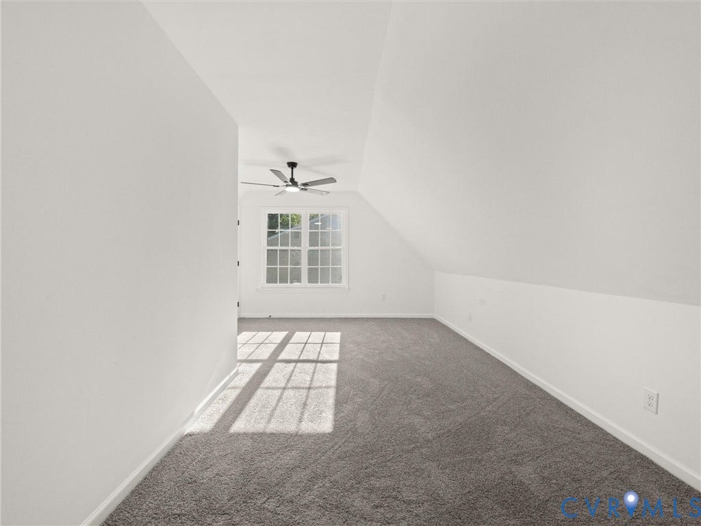 5105 Carryback Drive, Richmond, VA 23234 Neutral-toned carpeting, vaulted ceiling with architectural slope, multi-pane window, and integrated ceiling fan