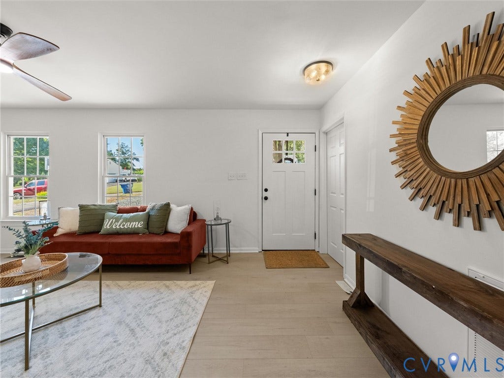 5105 Carryback Drive, Richmond, VA 23234 Wood-finish flooring throughout, white-painted interior walls, exterior door with multi-pane glass insert, flush-mount ceiling light fixture, and ceiling fan with integrated lighting