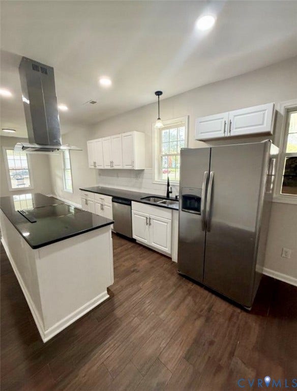1201 W Broadway, Hopewell, VA 23860 Kitchen featuring white shaker-style cabinetry, solid surface countertops, stainless steel appliances, a stainless steel range hood, and wood-finish flooring