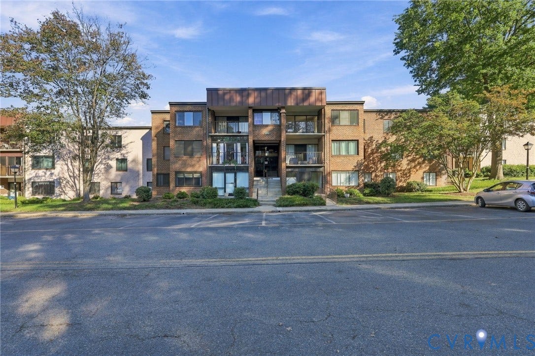 1503 Bronwyn Road, #303, Regency, Henrico, VA 23238 Multi-story brick exterior featuring recessed private balconies, copper-toned metal trim, and ground-level landscaping