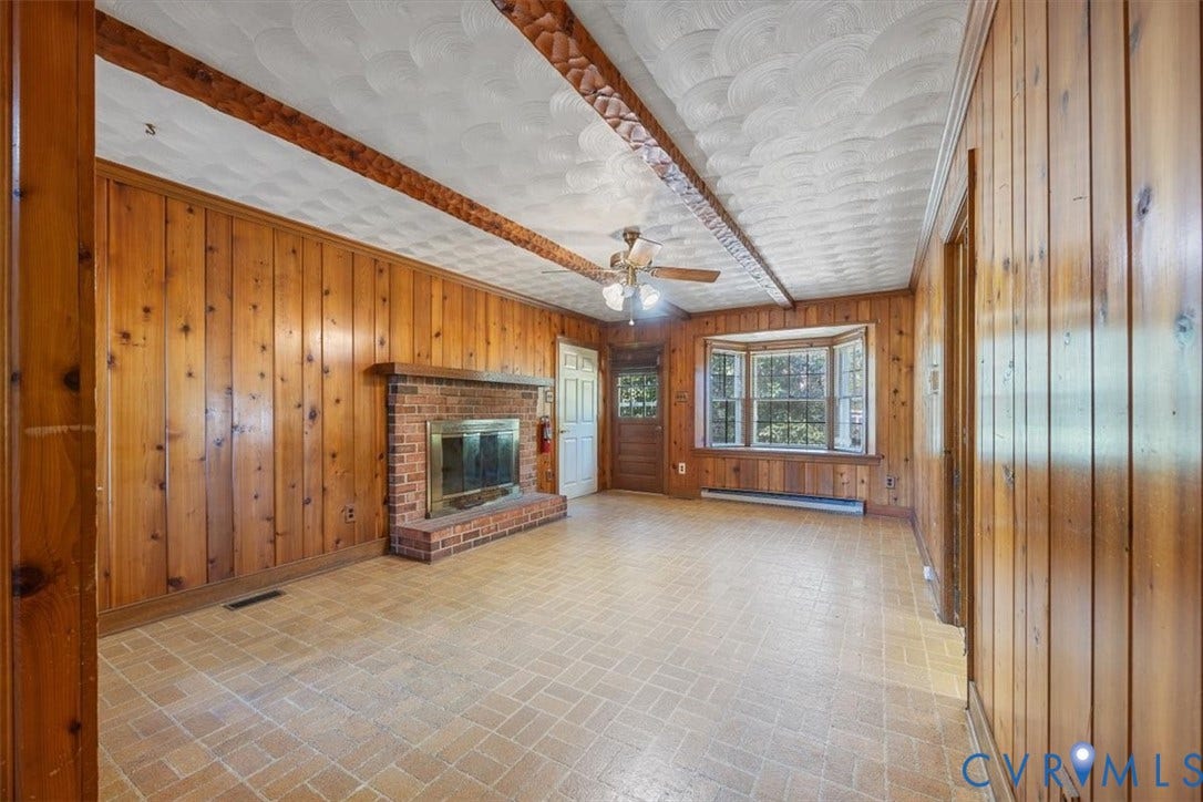 108 Jankin Lane, Sandston, VA 23150 Paneled walls in den with wood burning fireplace and bay window create a cozy atmosphere.