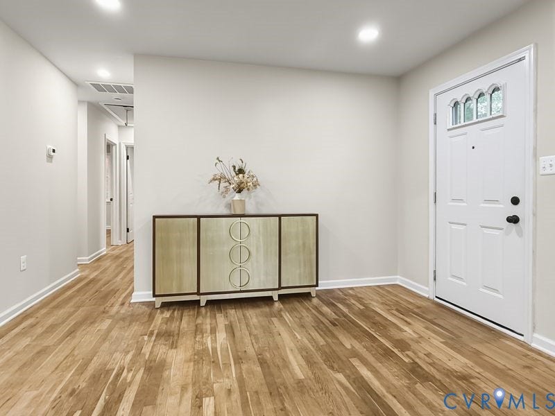 2500 ford Avenue, Richmond, VA 23223 Entryway featuring wood-finish flooring, recessed lighting, and a six-panel door with an arched glass insert