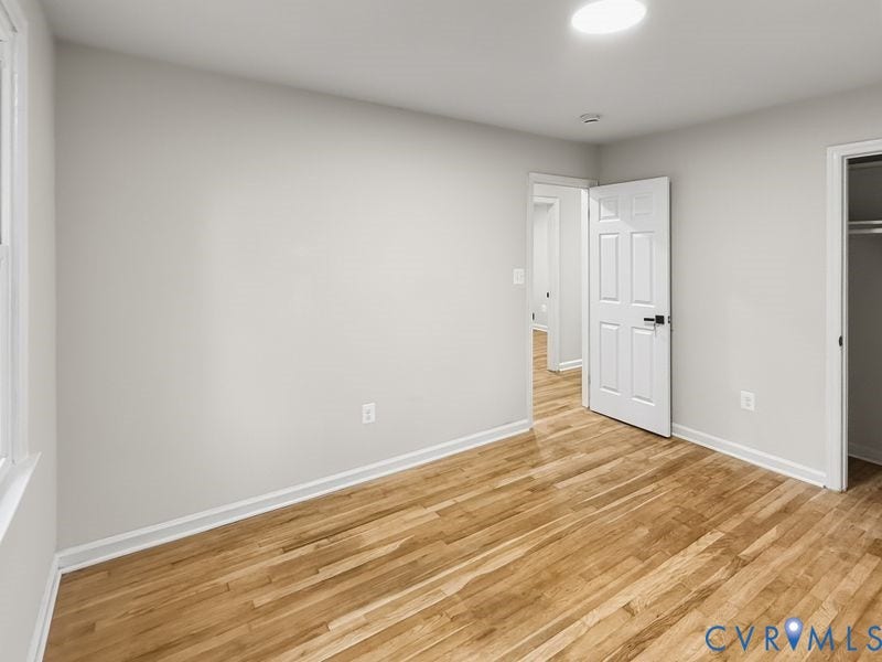 2500 ford Avenue, Richmond, VA 23223 Room featuring wood-finish flooring, neutral wall paint, recessed lighting, and a six-panel interior door