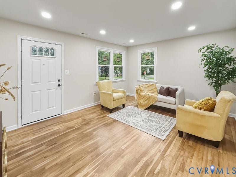 2500 ford Avenue, Richmond, VA 23223 Wood-finish flooring, recessed lighting, multi-pane entry door with arched glass detail, and dual-pane windows