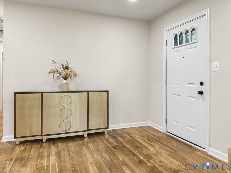 2500 ford Avenue, Richmond, VA 23223 White entry door with decorative glass transom, neutral wall finishes, and wood-finish flooring