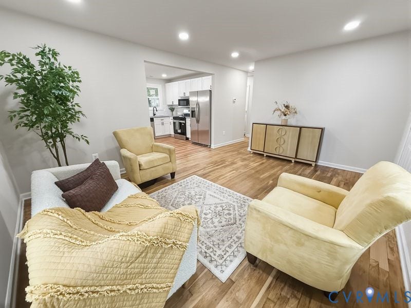 2500 ford Avenue, Richmond, VA 23223 Open-concept interior featuring wood-finish flooring, recessed lighting, and a kitchen equipped with white cabinetry and stainless steel appliances