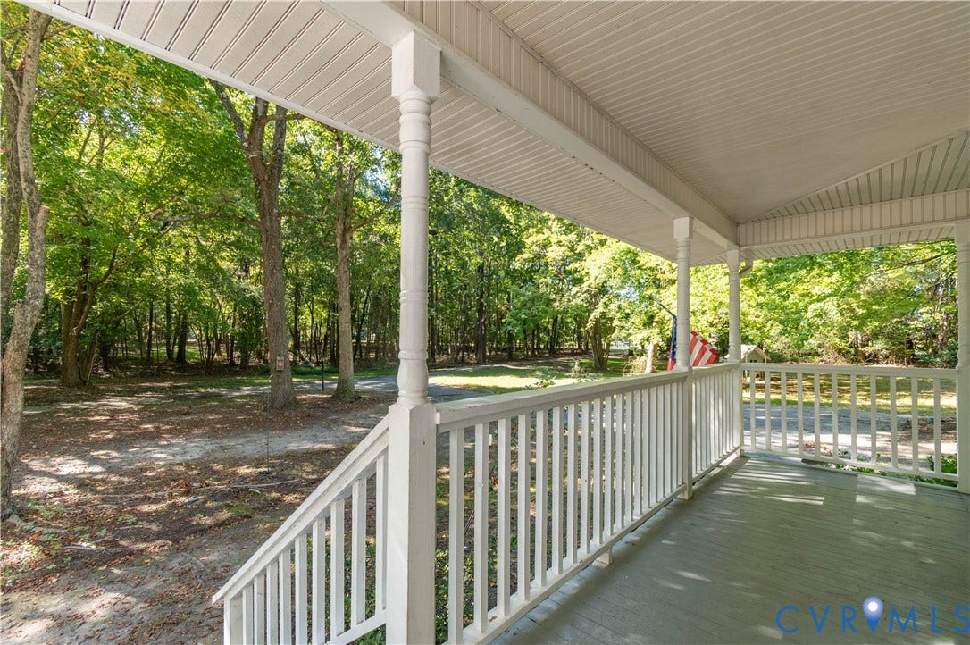 9045 Blounts Corner Road, Smithfield, VA 23430 Covered front porch featuring a wooden deck, painted railings, and structural posts