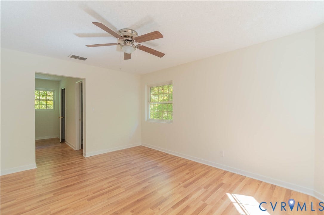 9045 Blounts Corner Road, Smithfield, VA 23430 Interior space featuring wood-finish flooring, a multi-blade ceiling fan with integrated lighting, and neutral wall paint