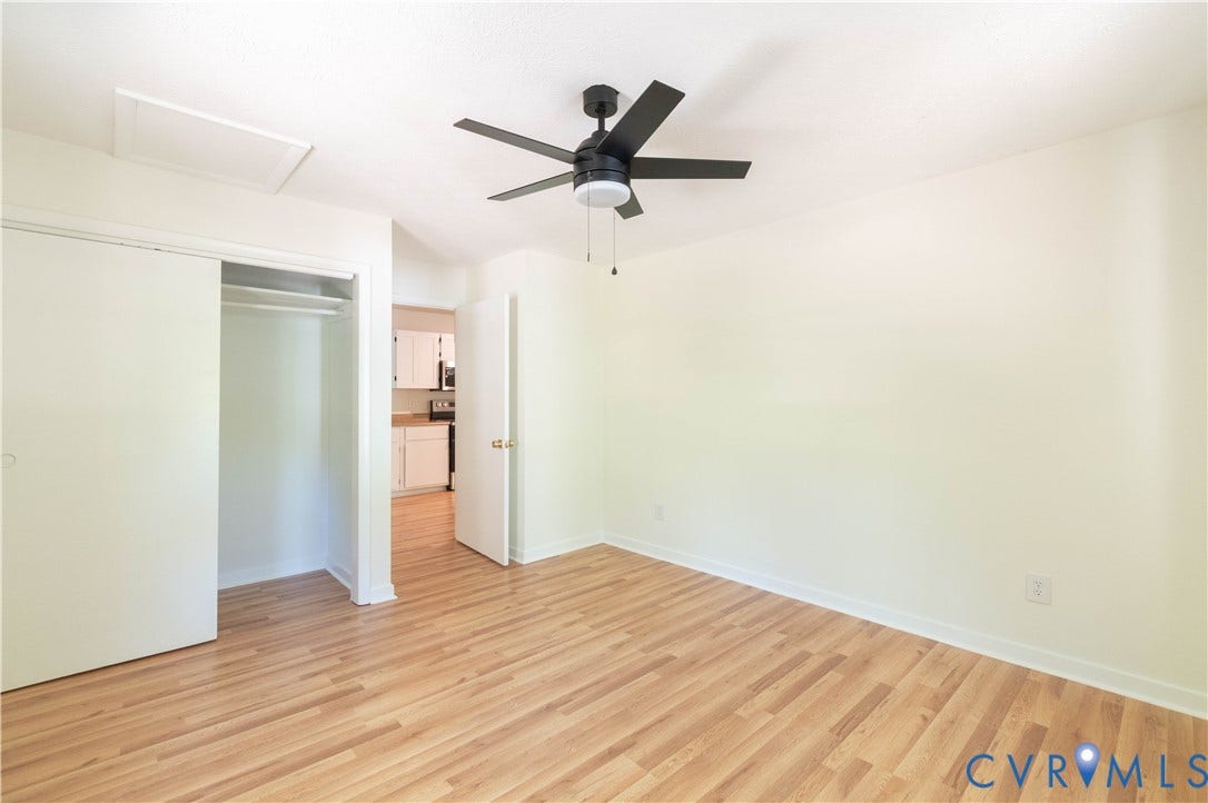 9045 Blounts Corner Road, Smithfield, VA 23430 Interior room featuring wood-finish flooring, a matte black ceiling fan with an integrated light fixture, and a sliding closet door
